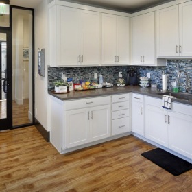 a kitchen with white cabinets and a coffeebar