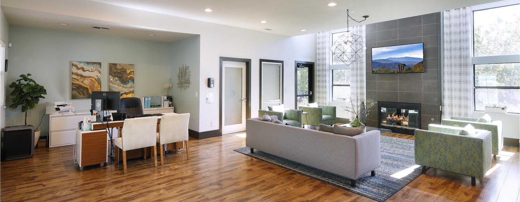 a large lounge room with a large tv and a couch and fireplace