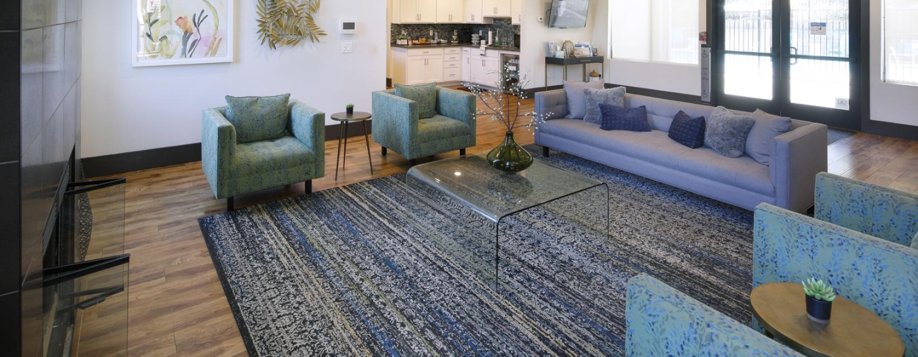 a lounge room with a rug and couches